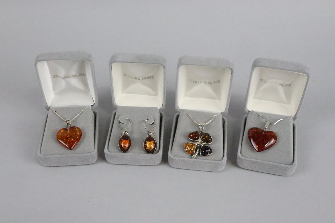 Two SS amber heart pendants on chains, SS amber 4 leaf clover pendant on chain, SS amber dangle earrings with flower detail