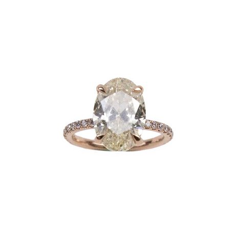 A 14k rose gold oval cut solitaire ring in imported setting
