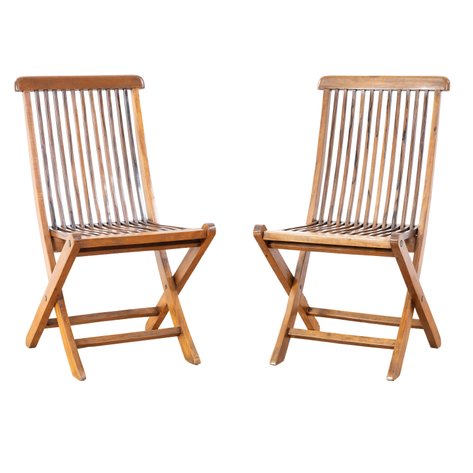 A pair of slatted campaign-style folding chairs