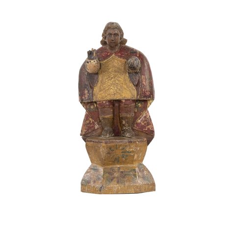 A de tallado folk Baroque image of the Santo Niño with elongated red tailcoat cape