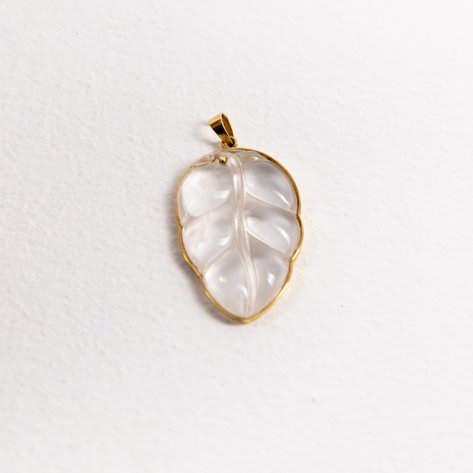A moonstone leaf pendant in 14k yellow gold