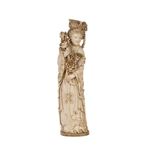 A finely carved ivory of a Chinese meiren or court beauty holding leafy stems of blooming peonies