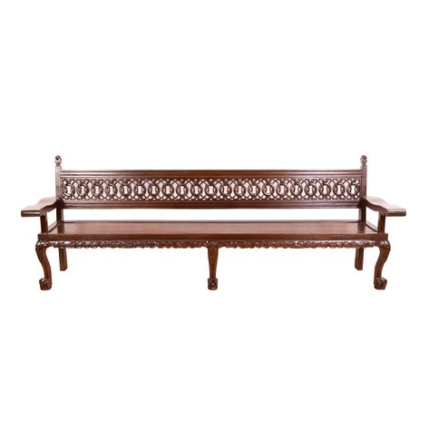 An Olympic style bench featuring a well-crafted openwork backrest with heavy lion mask and claw feet