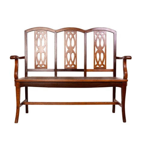 A transitional Art Deco settee with geometric fretwork splats