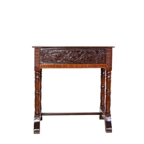 A primitive pebetera (sewing table) with archaic carved drawer decorations within reeded moldings