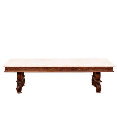 A large marble-top coffee table with carved Rococo Revival floral frieze and trestle base