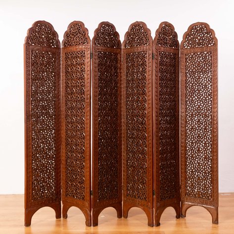A six-panel folding screen featuring elaborate openwork foliage and scrolling vine motifs