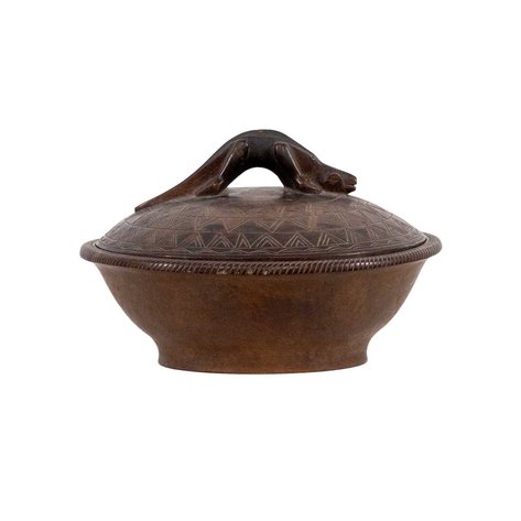 A hand-carved container featuring a distinctive lizard-shaped handle