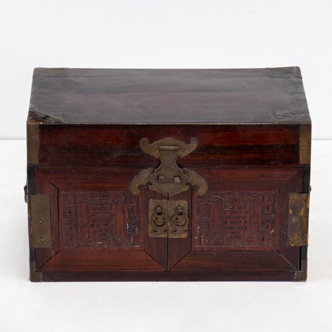 A Chinese traveling jewelry box, with tray and drawers behind double doors decorated with relief carvings for good fortune