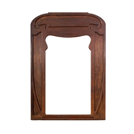 A monumental Art Nouveau mirror frame featuring deeply carved whiplash curves and cutouts in an elegant streamlined silhouette