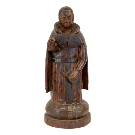 A folk style de tallado image of San Vicente Ferrer on circular base