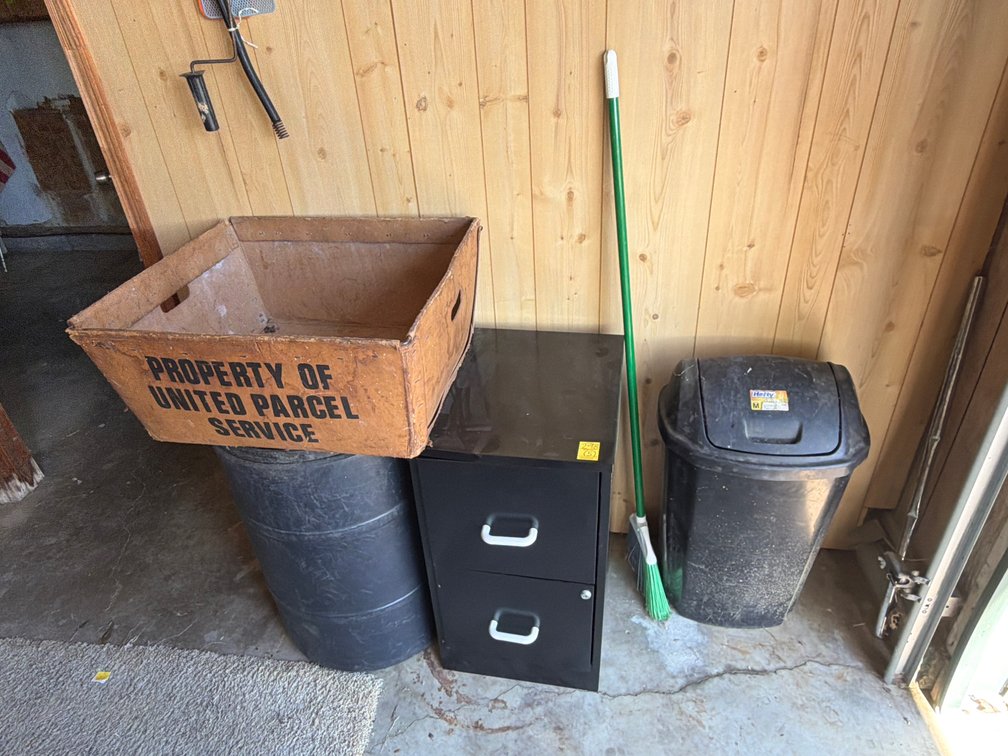 Barrel; trash can; file cabinet.