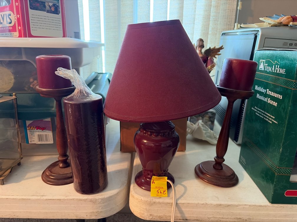 2 purple candles on wood stands; candle; purple lamp