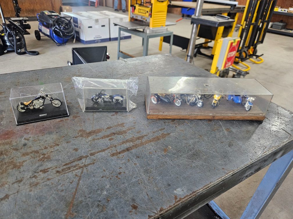 Assorted motorcycles in display boxes