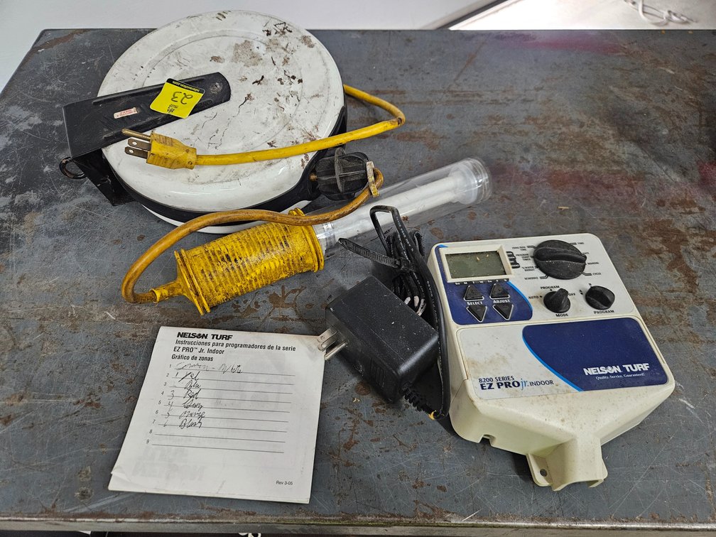Irrigation controller, cord reel shop light