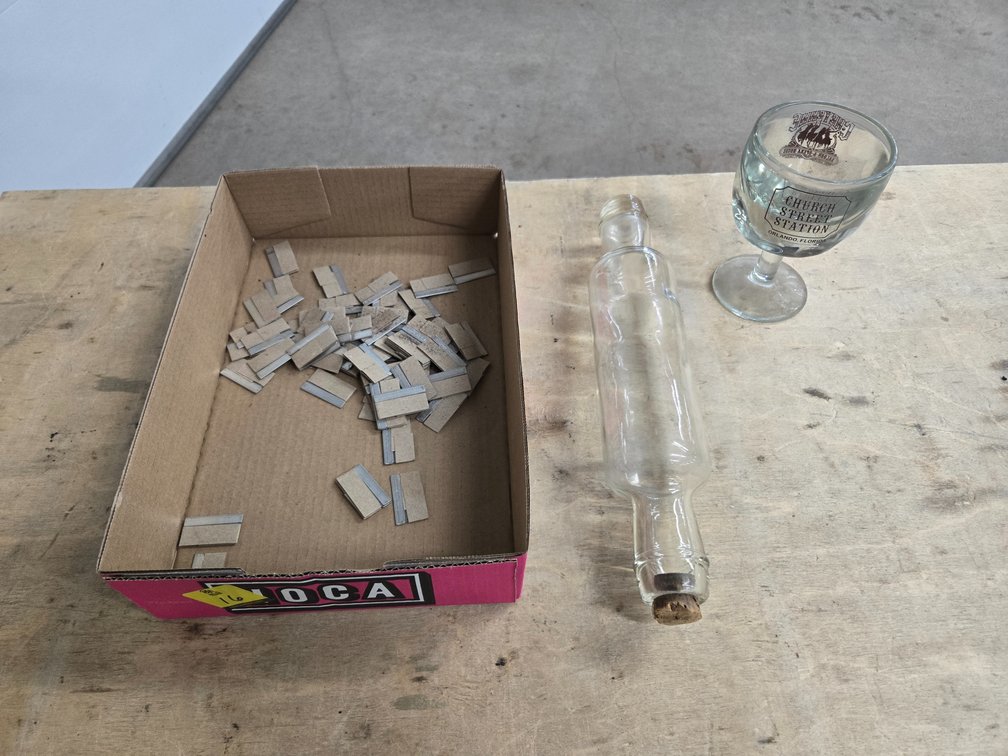 Razor blades, glass rolling pin and glass cup