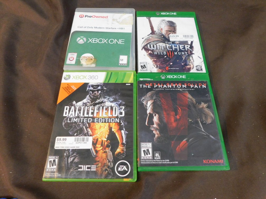 Three XBOX One games, The Phantom Pain, The Witcher 3: Wild Hunt, Call of Duty Modern Warfare, XBOX 360 Battlefield 3