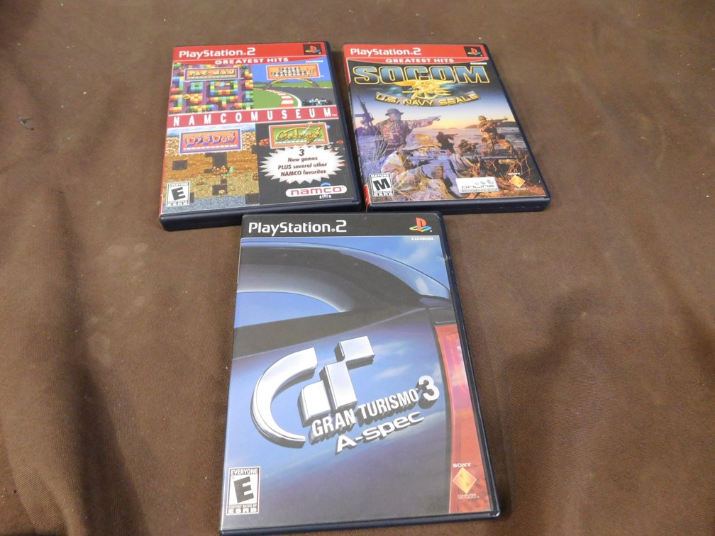 Three PlayStation 2 Video Games, Namco museum, Gran Turismo 3 A-spec, Socom: U.S. Navy Seals