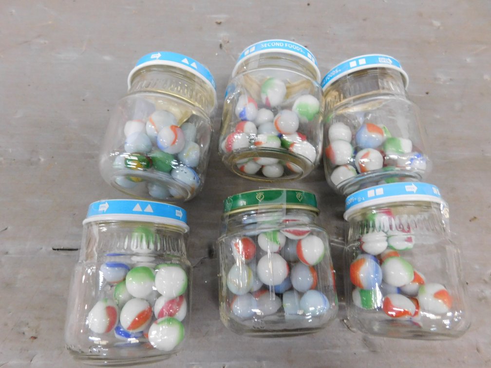 Six Baby Food Jars with Marbles