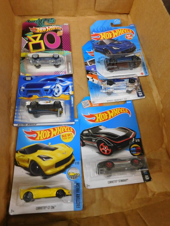 Six Assorted Hot Wheels Die Cast Cars in Sealed Packages