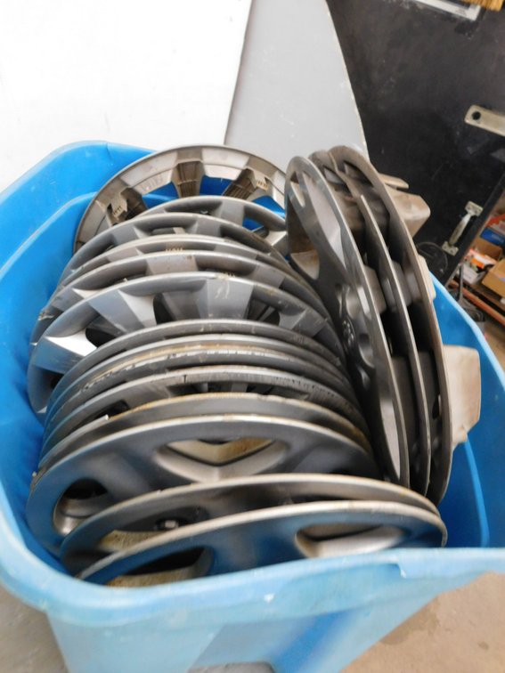 Tote full of Assorted Plastic Wheel Covers