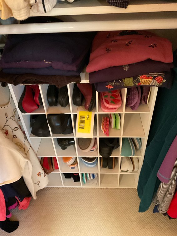 Miscellaneous sweaters/shoes in cubby
