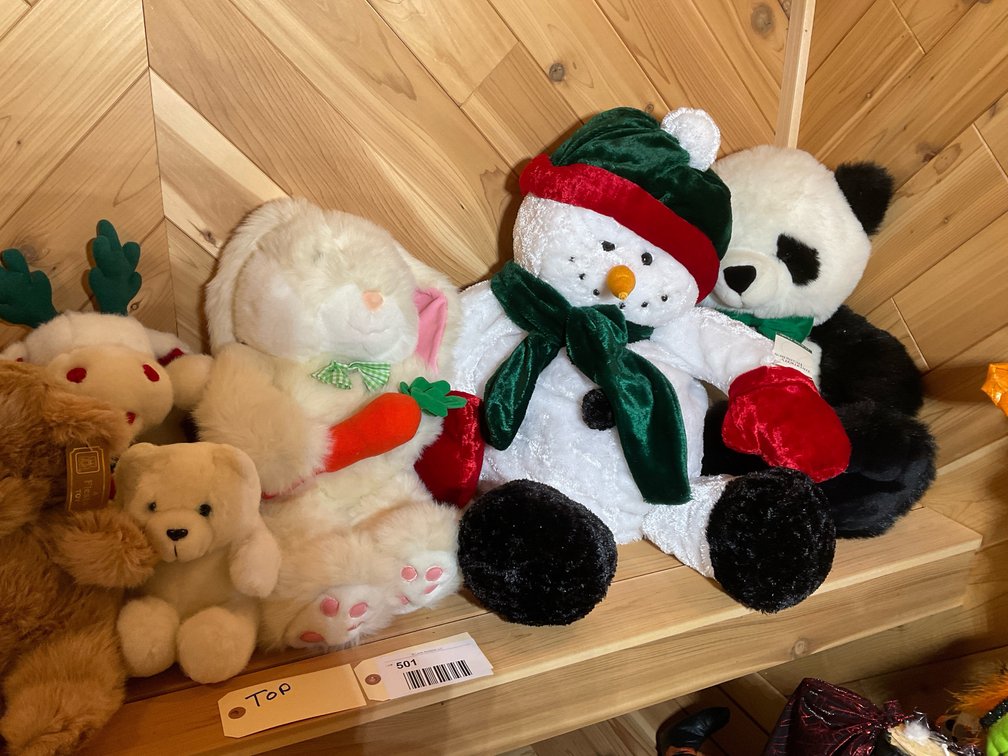 All stuffed animals on top bench