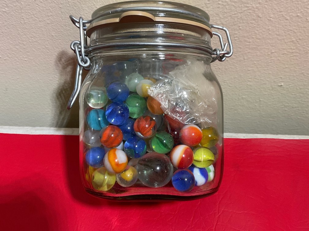 Miscellaneous marbles in jar
