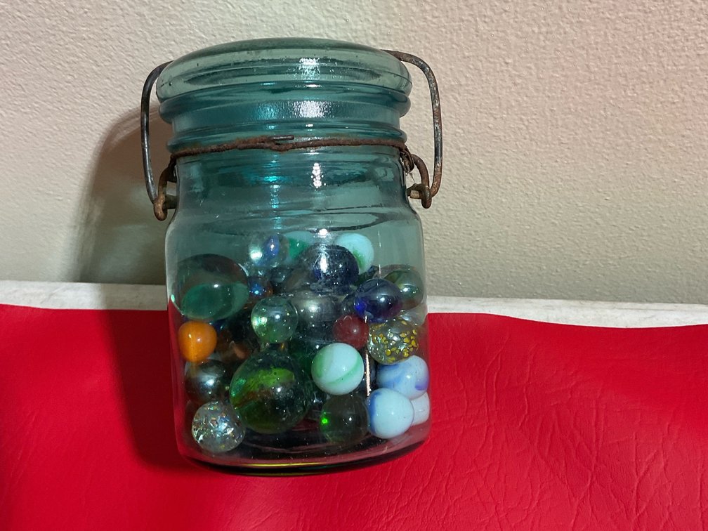 Blue jar with marbles