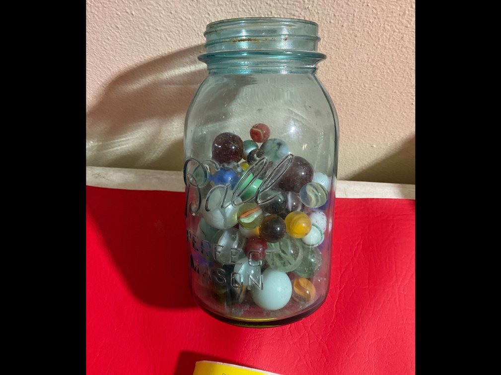Blue jar with marbles
