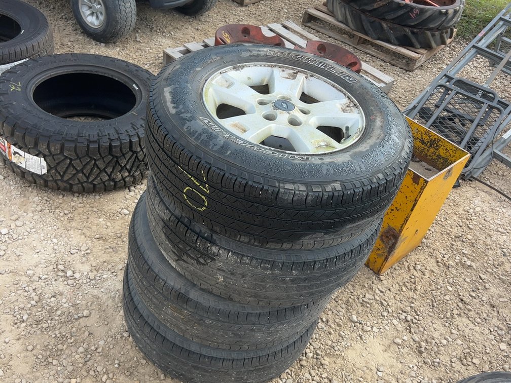 (4) 235/70R16 TIRES ON ALUMINUM RIMS