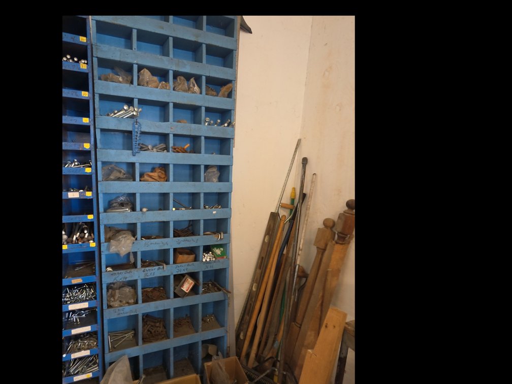 WOODEN PARTS BIN W/ ASSORTED PARTS & BOXES IN FRONT