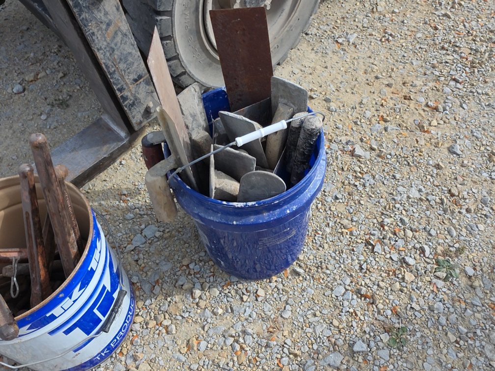 PAIL OF CEMENT TOOLS