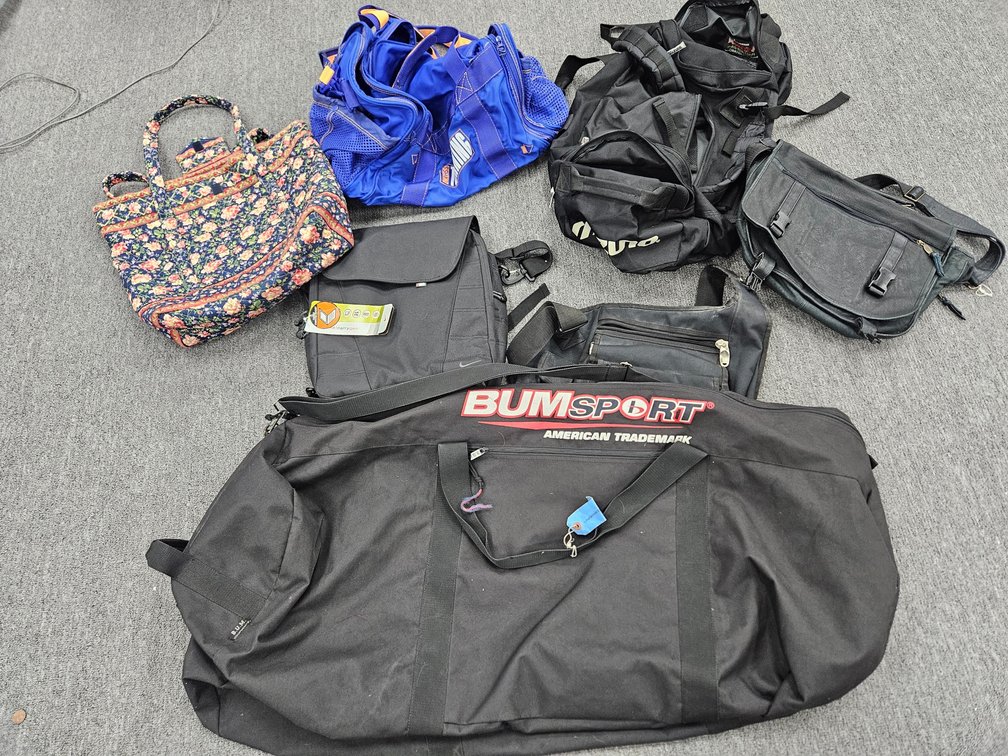 Assorted Nike, OGIO, and BUMSPORT Bags