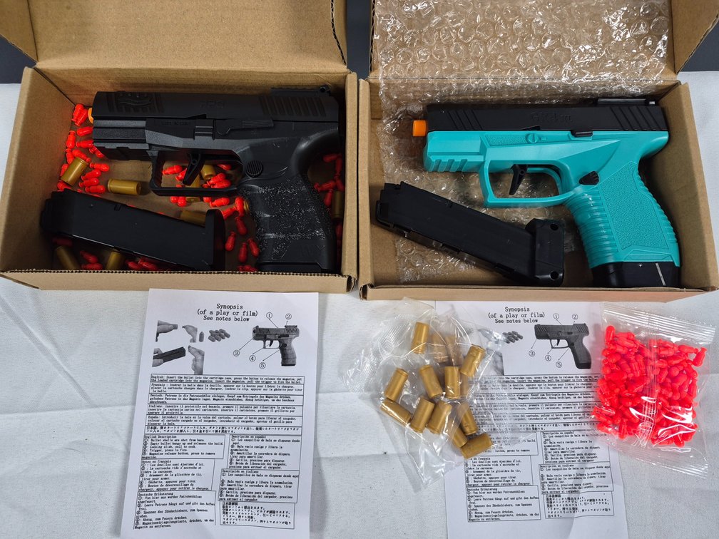 Two Toy Shell-Ejecting Pistols with Accessories