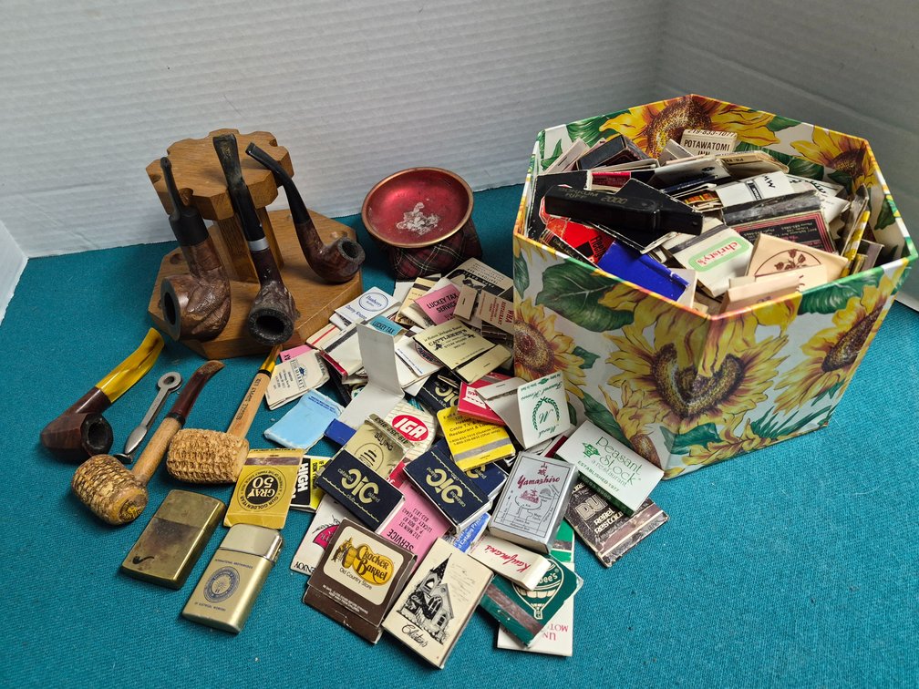 Smoking Pipes, Wooden Pipe Rack, Lighters, and Matchbooks