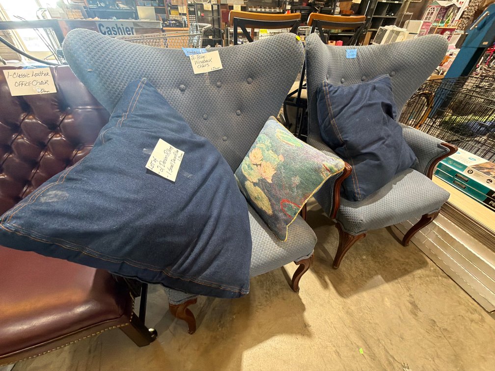 TWO BLUE WINGBACK CHAIRS AND PILLOWS