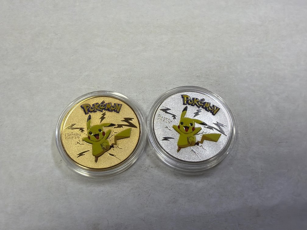 (2) COMMEMORATIVE POKEMON COINS