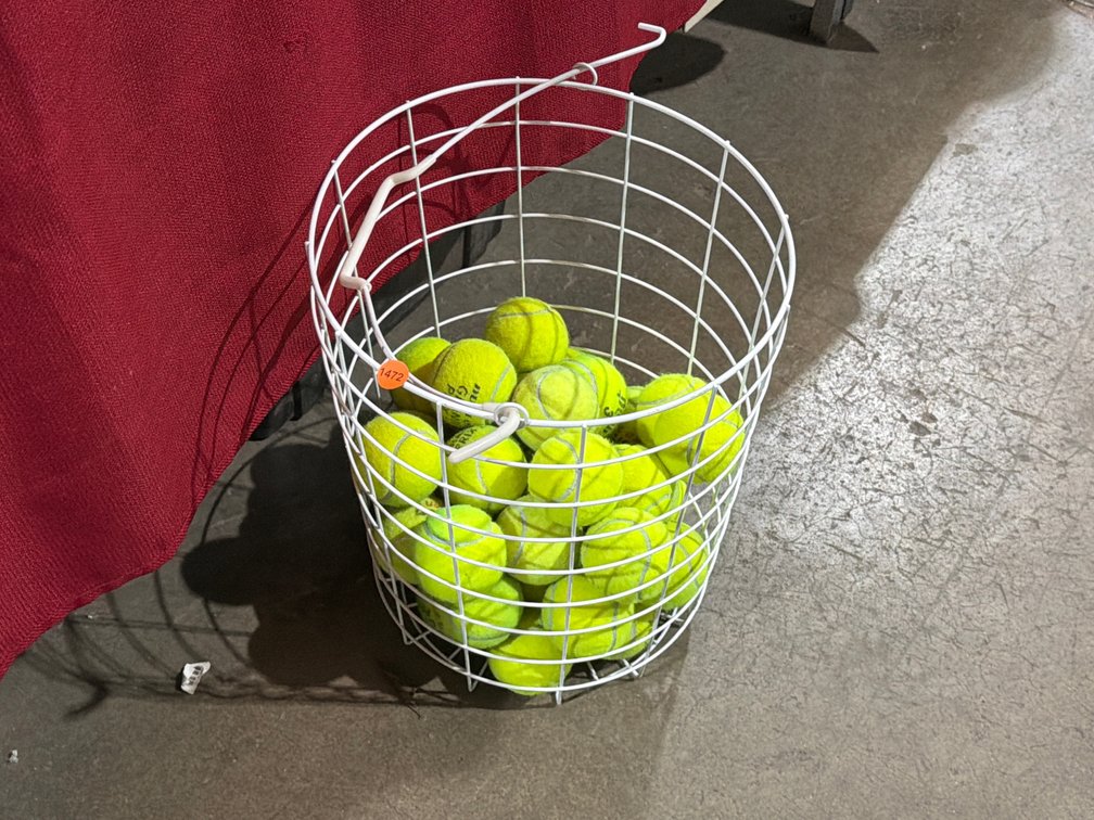 WIRE BASKET OF TENNIS BALLS