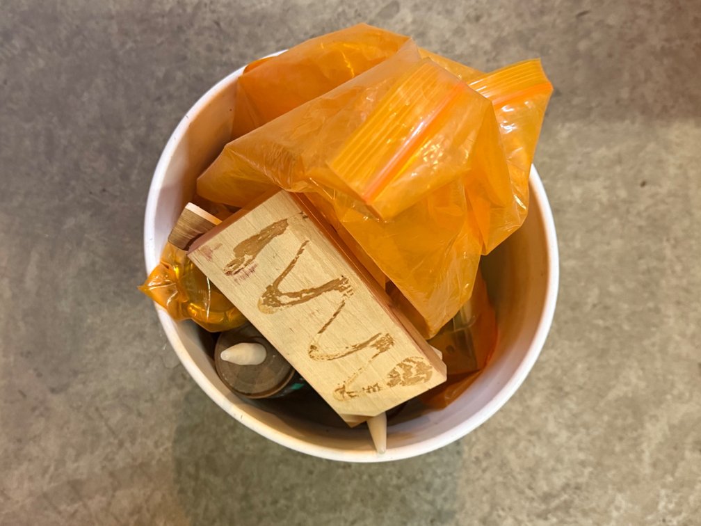 Bucket Of Constructive Adhesive, Sand Paper, And Finger Clusters