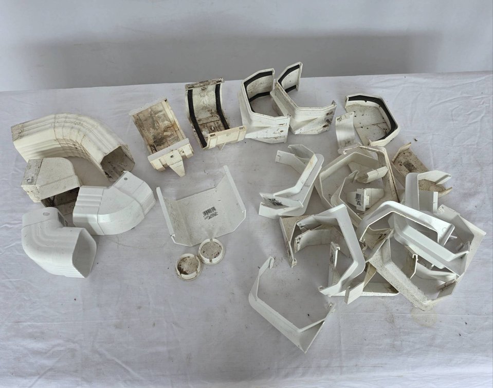 Various Plastic Gutter Fittings, Elbows, and Brackets