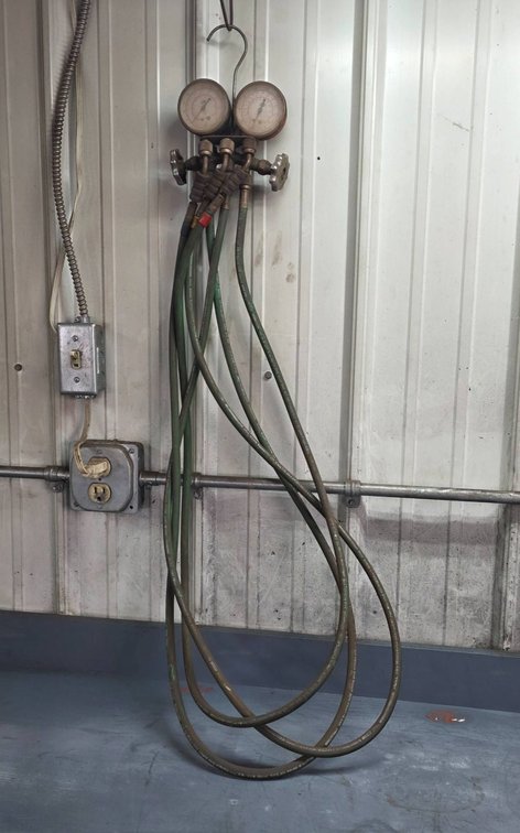 Automotive AC Recharging Hose Setup with Dual Gauges