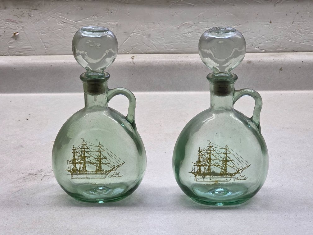 Antique Glass Whiskey Bottles with Old Ironsides Depiction