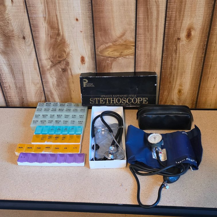 Medical Equipment Lot Including Sphygmomanometer, Stethoscope, and Pill Organizer