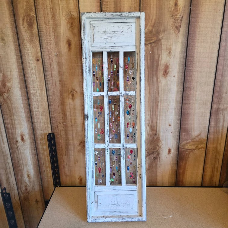 Distressed White Wood Panel with Beaded Decorations