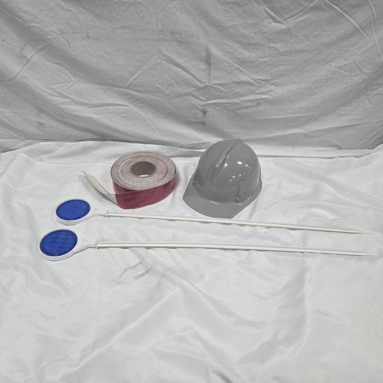 Safety Equipment: Gray Hard Hat, Reflective Tape Roll, Two Blue Reflectors
