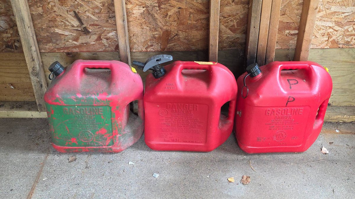 Three Red Plastic 5 Gallon Gas Cans, Two Full and One Empty, Portable Fuel Containers with Caps and Spout