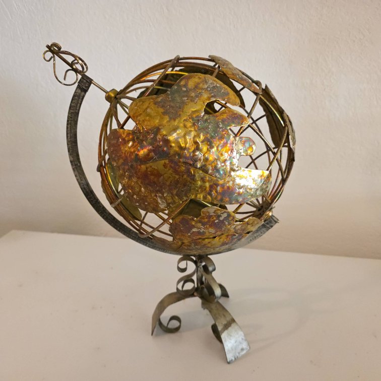 Handcrafted Metal Globe Sculpture With Hammered Continents and Scrollwork Stand
