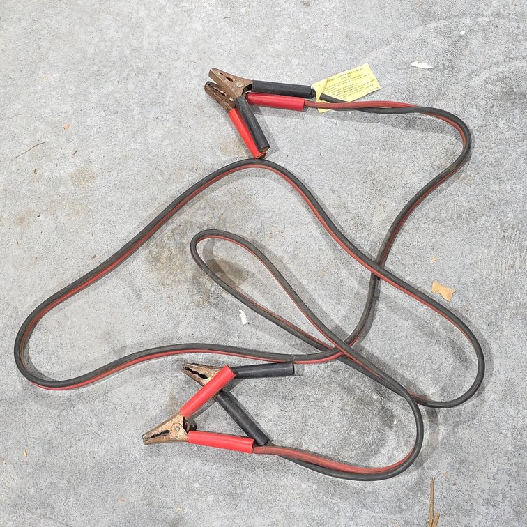 Heavy-Duty Jumper Cables with Red and Black Clamps, Show Signs of Use and Age, Fully Functional