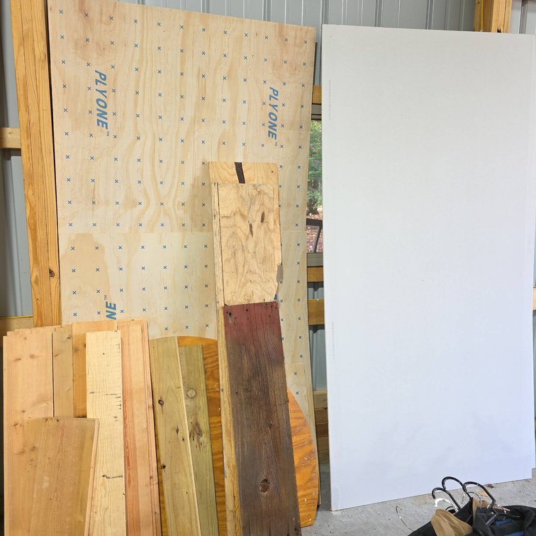 Two 4x8 Quarter Inch Underlayment Sheets, One 4x8 Half Inch Gypsum Board, and Scrap Lumber